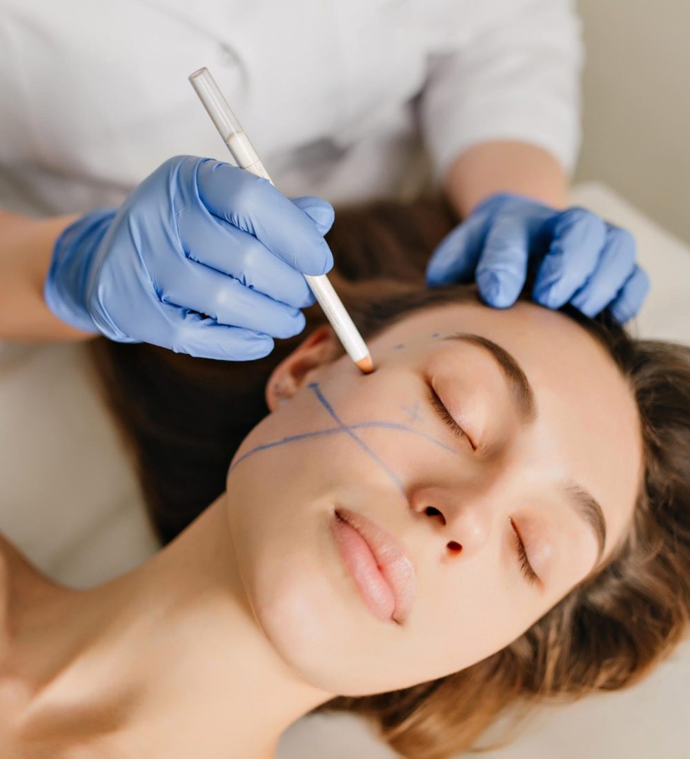 Closeup portrait of beautiful woman during the preparation to cosmetology therapy in beauty salon. Professional dermatology procedures, lifting, rejuvenation